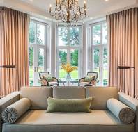 A bright lounge with wide windows and chandelier