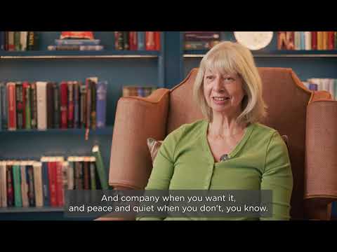 Preview image for the video "Audley Scarcroft Park - Owners Testimonial" - A woman with gray hair, wearing a green top, sits in a chair in a room with bookshelves. The subtitle reads, "And company when you want it, and peace and quiet when you don’t, you know..