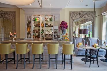 Stools at an immaculate, sunlit bar
