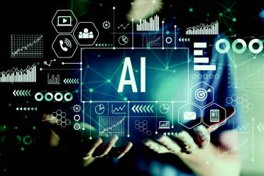 A person holds a digital interface displaying the text "AI" surrounded by various technology and data-related icons and graphics.