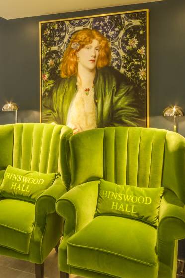 Comfortable green chairs, large pre-Raphaelite paintings and blue/white pots