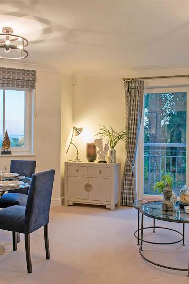 Bright living room with french doors and dining area