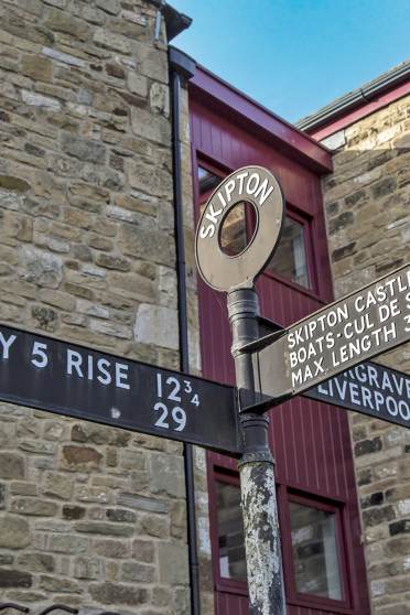 Old fashion road sign with direction plates