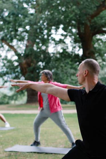 Yoga class in a park with trees
