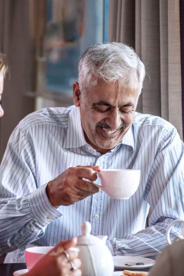 Couple enjoying tea with carer