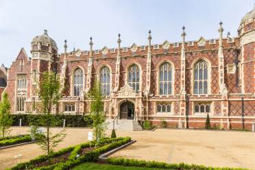 Exterior of Binswood Hall in Leamington Spa. Tudor styled red brick building with large windows.