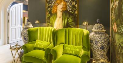 Comfortable green chairs, large pre-Raphaelite paintings and blue/white pots