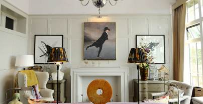 Bright wood-panelled drawing room with art pieces