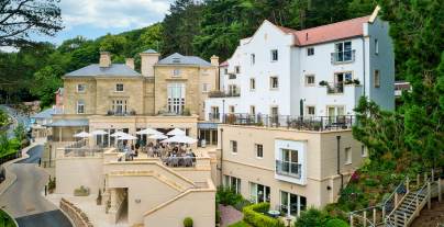 Stone building with apartments and restaurant terrace