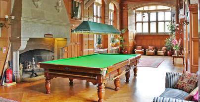 Green baize billiard table in grand panelled hall