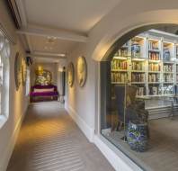 Period hallway with large window into library