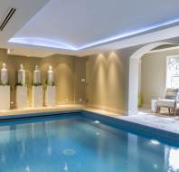 Blue indoor pool in calm surroundings with mood lighting