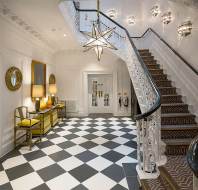 Manor house hall with chess tiles and splendid staircase