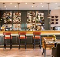 Well-lit bar with stools and polished fittings