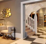 Entrance hall with staircase, seating and chequerboard floor