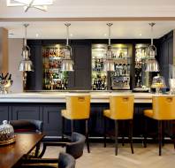 Marble-topped bar with tall yellow stools