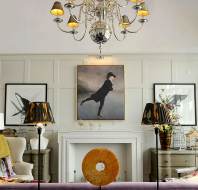Bright wood-panelled drawing room with art pieces