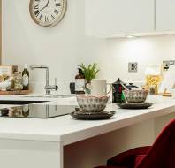 Two coffee cups on a white kitchen surface