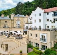 Stone building with apartments and restaurant terrace