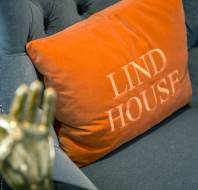 Orange cushion branded "Lind House"