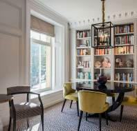Mustard armchairs with round table in library