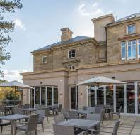 Restaurant terrace and pale-stone mansion