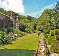 Formal garden with high stone wall