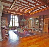 Wood-panelled library with parquet floor