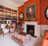 Luxury lounge with bookshelves and large fireplace