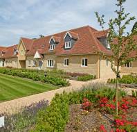 Stone cottages with lawns and flowers