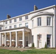 Pale stone mansion against a blue sky