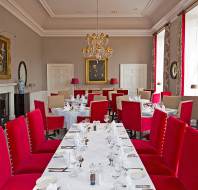 Long table with red dining chairs 