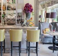 Stools at an immaculate, sunlit bar