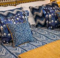 Bed with patterned throw and cushions