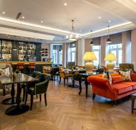 Bar area with tables and orange sofa