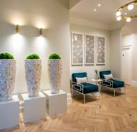 Plush loungers and plants in softly lit reception area