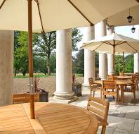 Shaded tables amid stone columns