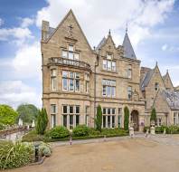 Victorian gothic stone buildings under a blue sky