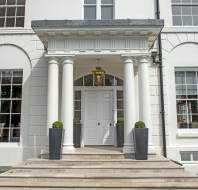 Covered entrance with pale stone steps