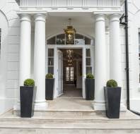 Covered entrance with columns and stone steps