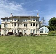 Mansion with lawn and croquet hoops