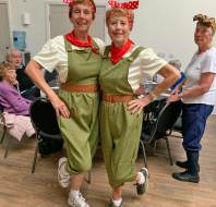 Two women wearing Land Army costumes