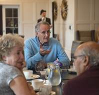 Group in conversation over dining table