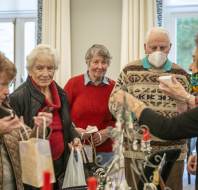 People buying from a Christmas stall