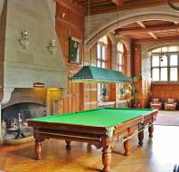 Green baize billiard table in grand panelled hall