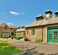 Converted stone stables with green doors