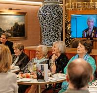 People seated to watch video presentation