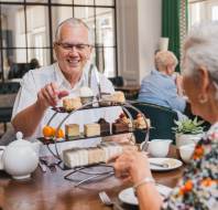 Couple enjoying afternoon tea in bristol retirement village