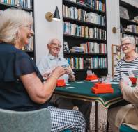 Owners playing cards in a retirement village