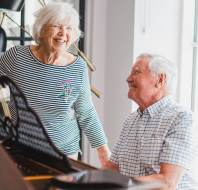 Owners playing the piano and laughing